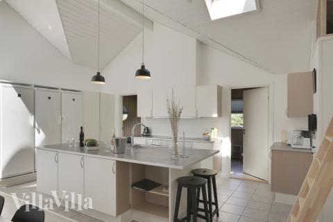 Køkkenet der er i åben forbindelse med stuen og spisepladserne, har dobbelt opvaskemaskine, dobbelt el-komfur, dobbelt køleskab, mikroovn og fryser