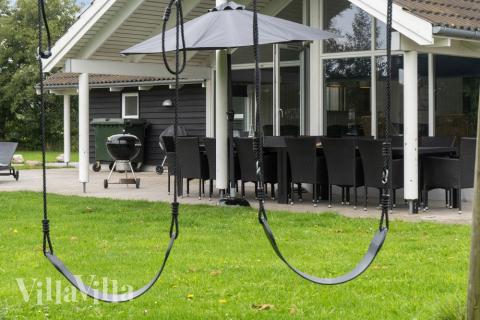 I det attraktive aktivitesrum i luksushus nr. 212 i Lolland/Falster/Møn  er der masser af udendørs aktiviteter, f.eks. legetårn og gynge
