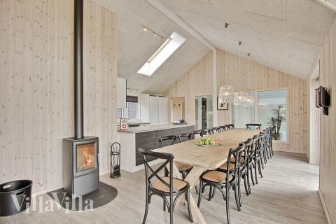 Opholdsrummet er dejligt lyst og rummeligt, og husets helt naturlige samlingspunkt. Der er kig ind til vandhundene i poolrummet.