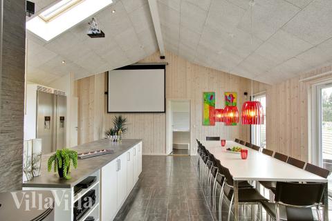 I opholdsrummet står lærred og projektor til rådighed for gæsterne.