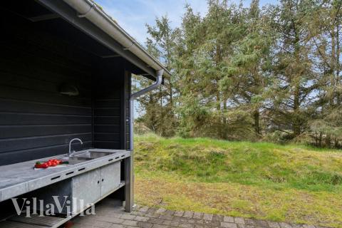 I det attraktive aktivitesrum i luksushus nr. 371 i Vestjylland  er der masser af udendørs aktiviteter, f.eks. legetårn og gynge