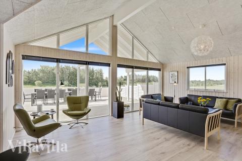 I kan sagtens side 18 personer sammen i sommerhusets opholdsrum, når I besøger luksushus 405 i Limfjorden.