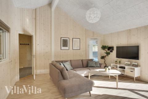 I kan sagtens side 24 personer sammen i sommerhusets opholdsrum, når I besøger luksushus 406 i Nordsjælland.