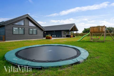 I det attraktive aktivitesrum i luksushus nr. 453 i Vestjylland  er der masser af udendørs aktiviteter, f.eks. legetårn og gynge