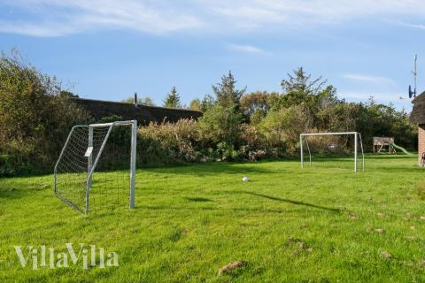 I det attraktive aktivitesrum i luksushus nr. 557 i Vestjylland  er der masser af udendørs aktiviteter, f.eks. legetårn og gynge